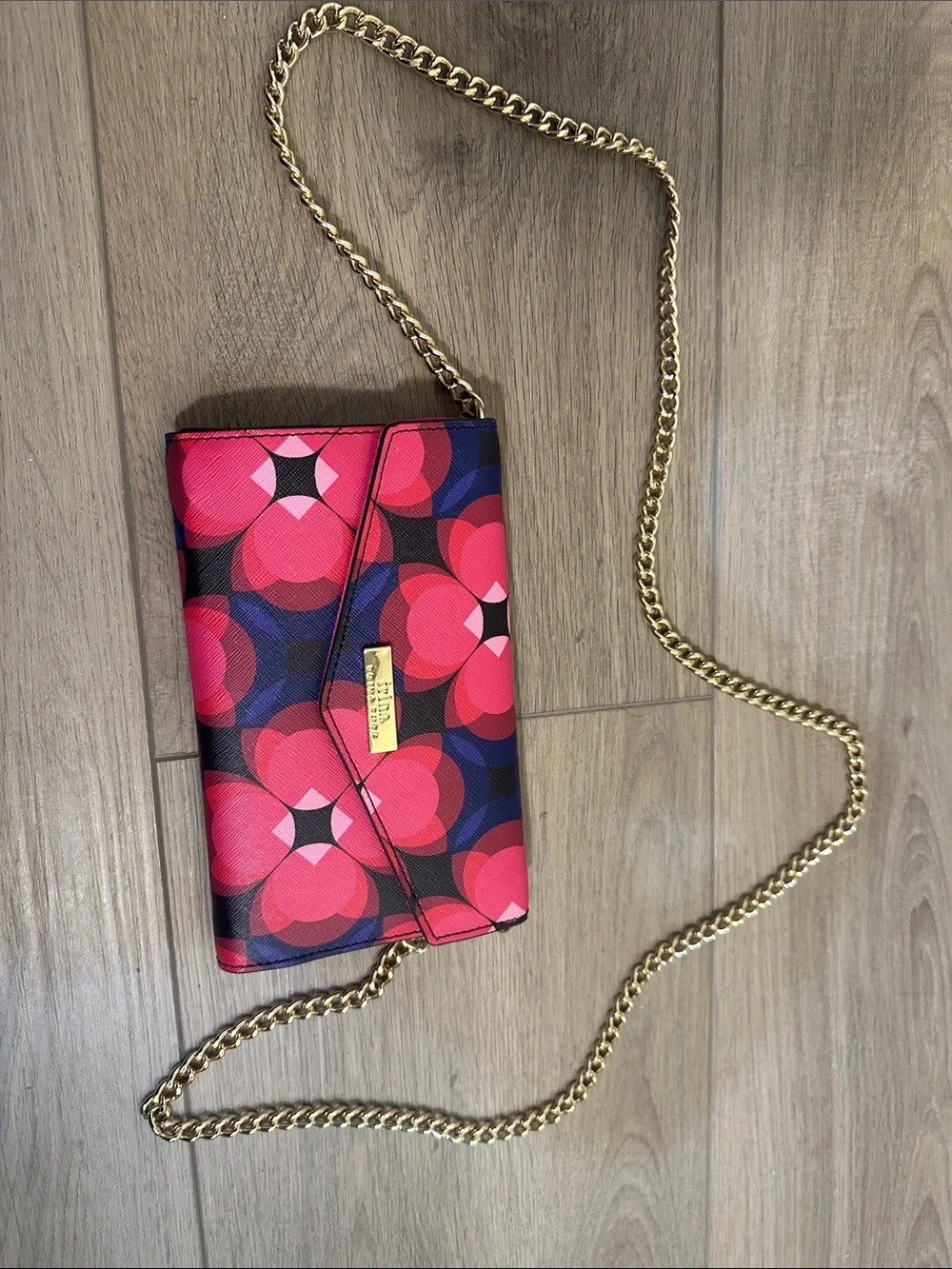 Trina Turk pink, red, black and blue cross body clutch with gold tone chain